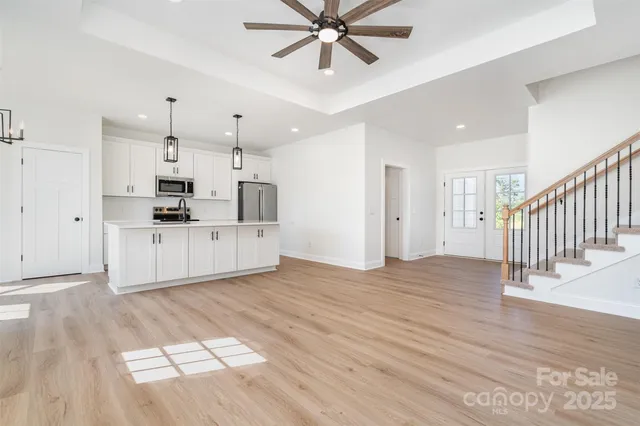 a view of a kitchen with wooden floor and window