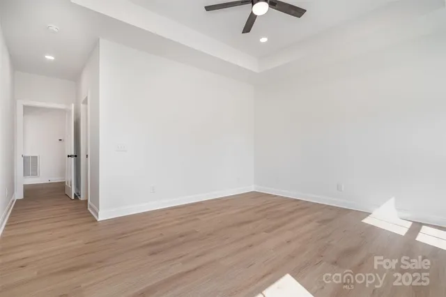 a view of an empty room with wooden floor