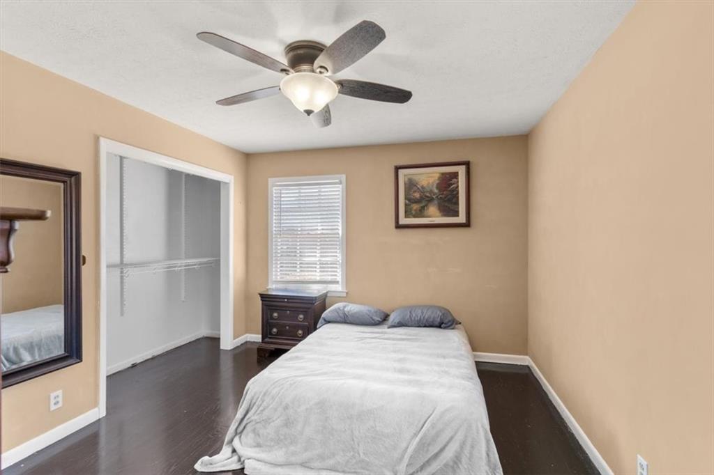 213 Cook Street Cartersville, GA 30120 - Photo 22 of 45 a bedroom with a large bed and a chandelier