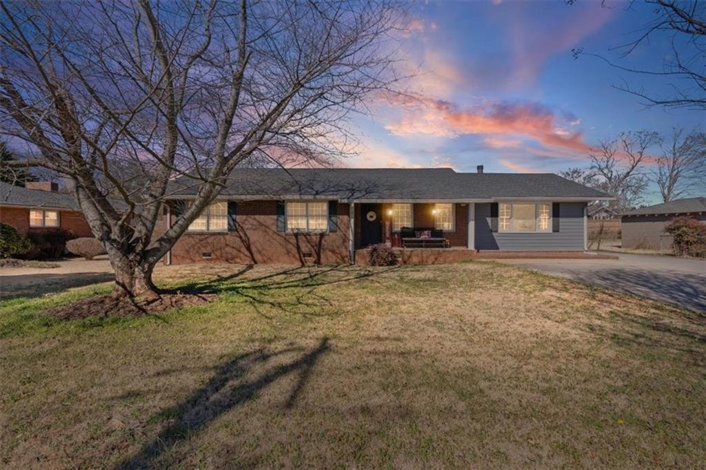 213 Cook Street Cartersville, GA 30120 - Photo 27 of 45 a view of a house with a yard tree and wooden fence