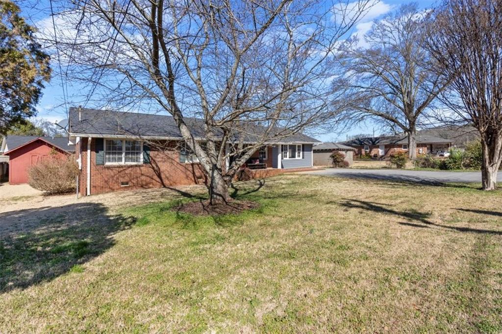 213 Cook Street Cartersville, GA 30120 - Photo 29 of 45 a backyard of a house with barbeque oven table and chairs