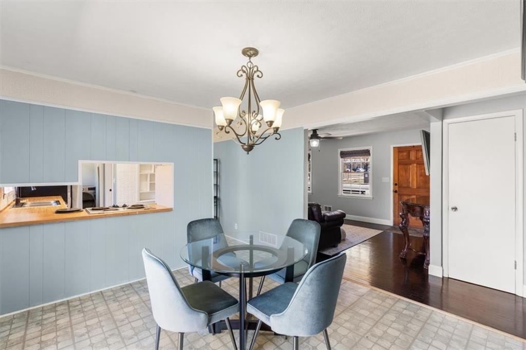 213 Cook Street Cartersville, GA 30120 - Photo 7 of 45 a dining room with wooden floor a chandelier a wooden table and chairs