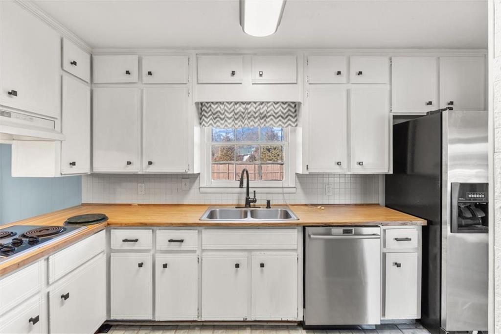 213 Cook Street Cartersville, GA 30120 - Photo 9 of 45 a kitchen with granite countertop white cabinets and stainless steel appliances