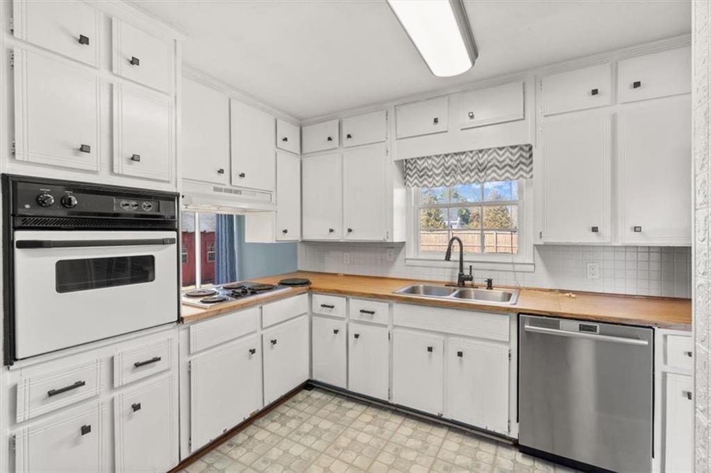 213 Cook Street Cartersville, GA 30120 - Photo 10 of 45 a kitchen with white cabinets sink and white appliances