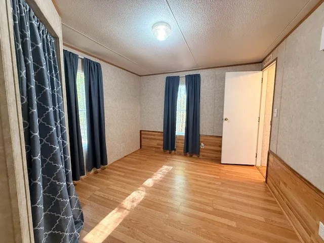 a view of a room with wooden floor and windows