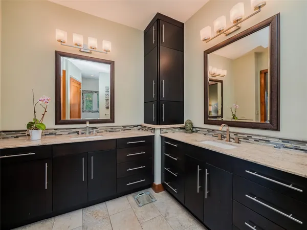 a bathroom with a double vanity sink and a mirror
