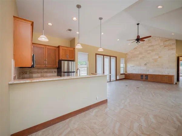 a view of a kitchen with a sink and refrigerator