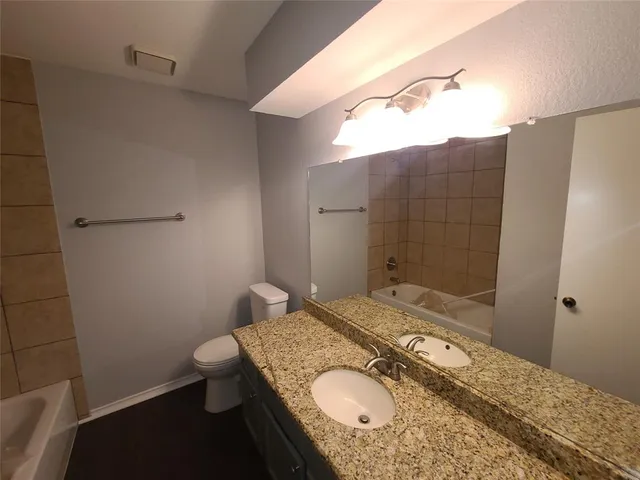 a bathroom with a tub and toilet