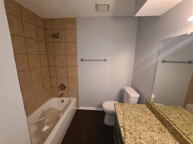 an empty room with a chandelier fan and window