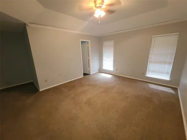 an empty room with an empty space and windows