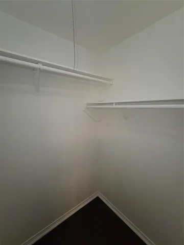 a white toilet sitting next to a white walls