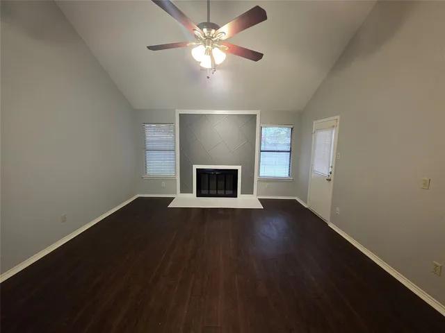 a view of empty room with a fireplace
