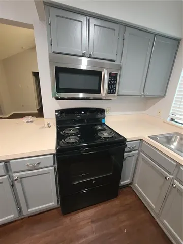 an empty room with a fan & a window