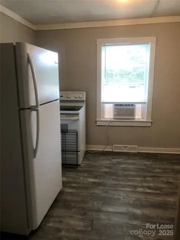 a view of a refrigerator in kitchen and wooden floor