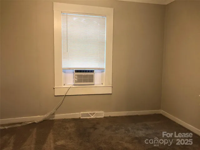 a room with a wooden floor and a window