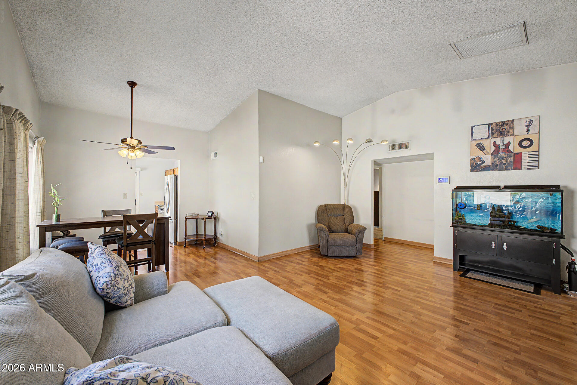 2659 West Hearn Road Phoenix, AZ 85023 - Photo 4 of 25 a living room with furniture and a flat screen tv