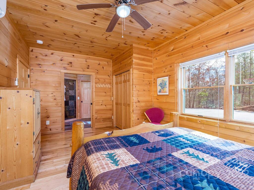 206 Legend Dr Mill Spring, Unit 8 Mill Spring, NC 28756 - Photo 25 of 47 a bedroom with a bed and wooden floor