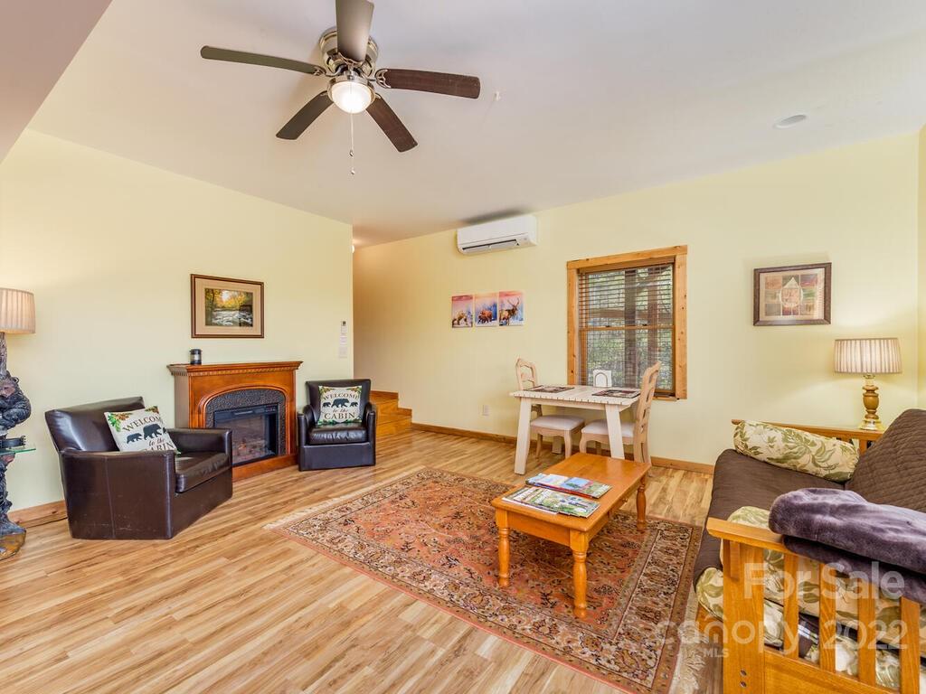 206 Legend Dr Mill Spring, Unit 8 Mill Spring, NC 28756 - Photo 35 of 47 a living room with furniture and a wooden floor