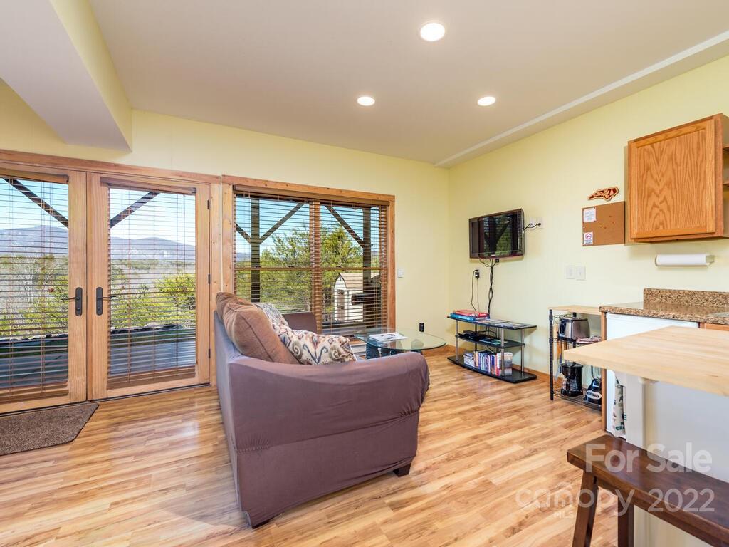 206 Legend Dr Mill Spring, Unit 8 Mill Spring, NC 28756 - Photo 37 of 47 a living room with furniture and a wooden floor
