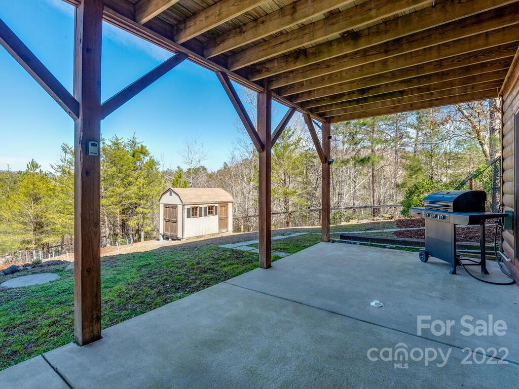206 Legend Dr Mill Spring, Unit 8 Mill Spring, NC 28756 - Photo 38 of 47 a view of a porch with chairs and backyard