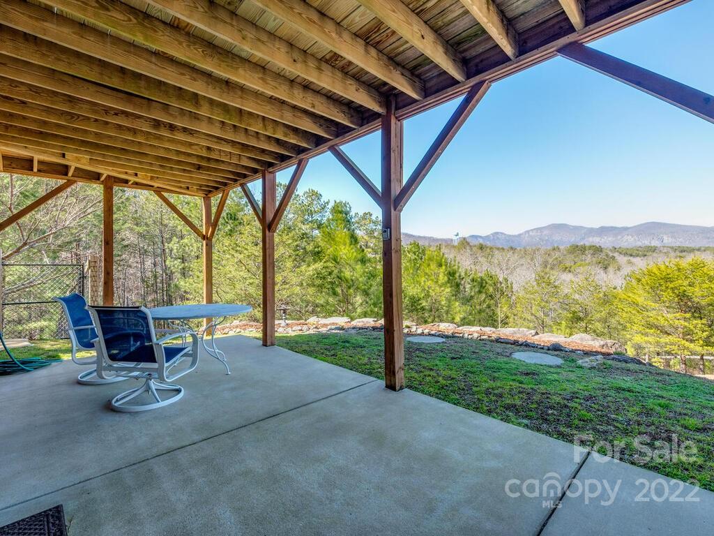 206 Legend Dr Mill Spring, Unit 8 Mill Spring, NC 28756 - Photo 39 of 47 a view of a porch with furniture and backyard