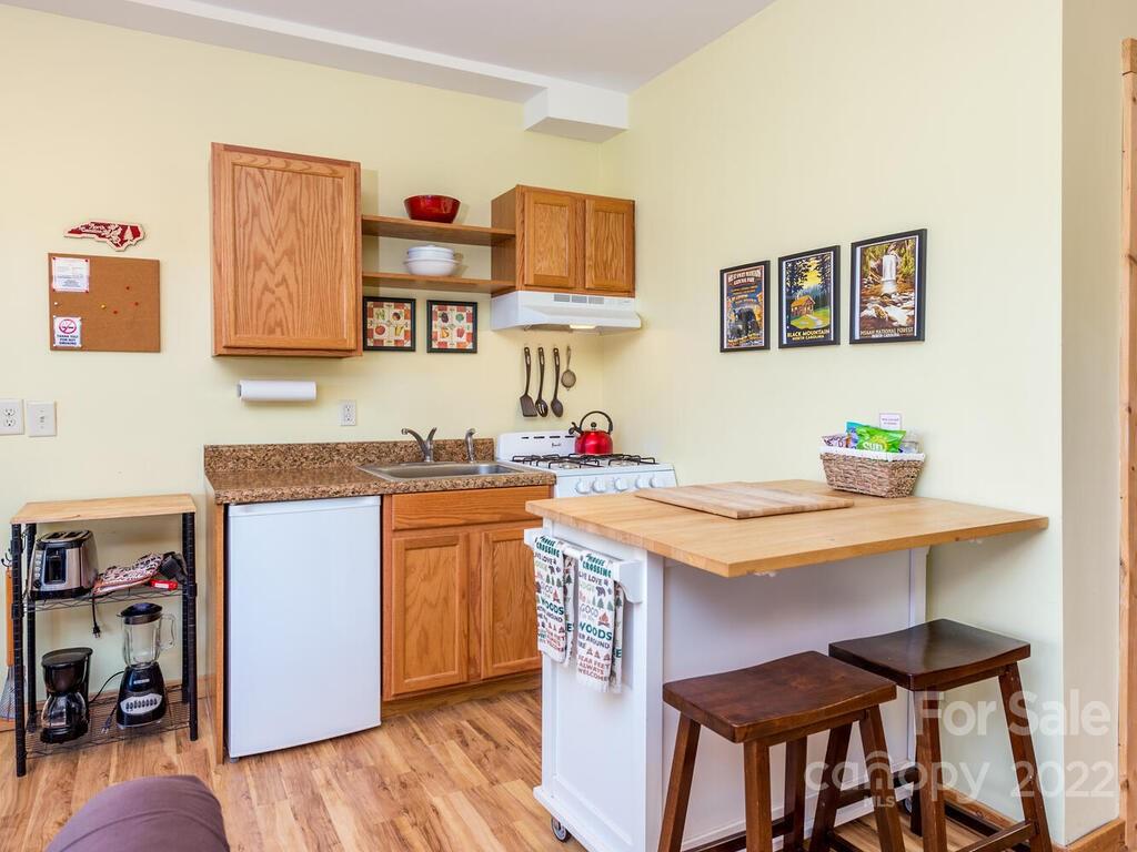 206 Legend Dr Mill Spring, Unit 8 Mill Spring, NC 28756 - Photo 40 of 47 a open kitchen with a table and chairs in it