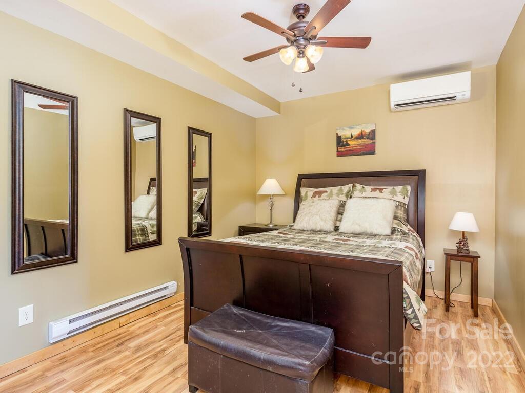 206 Legend Dr Mill Spring, Unit 8 Mill Spring, NC 28756 - Photo 41 of 47 a bedroom with a bed wooden floor and window