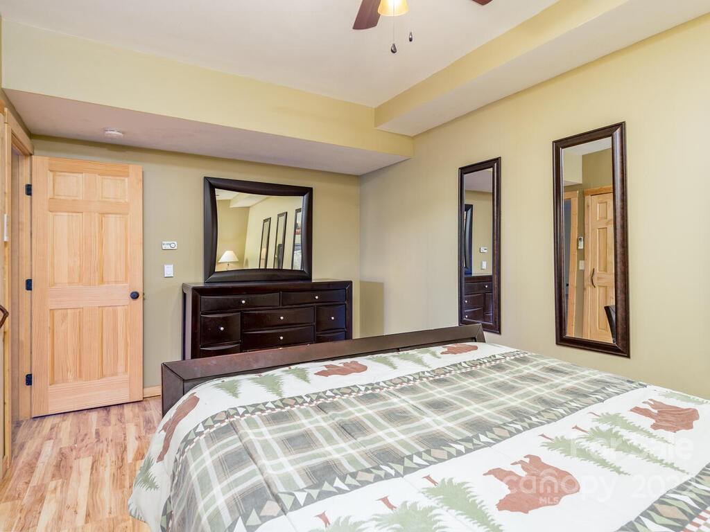 206 Legend Dr Mill Spring, Unit 8 Mill Spring, NC 28756 - Photo 42 of 47 a bedroom with a bed and a dresser