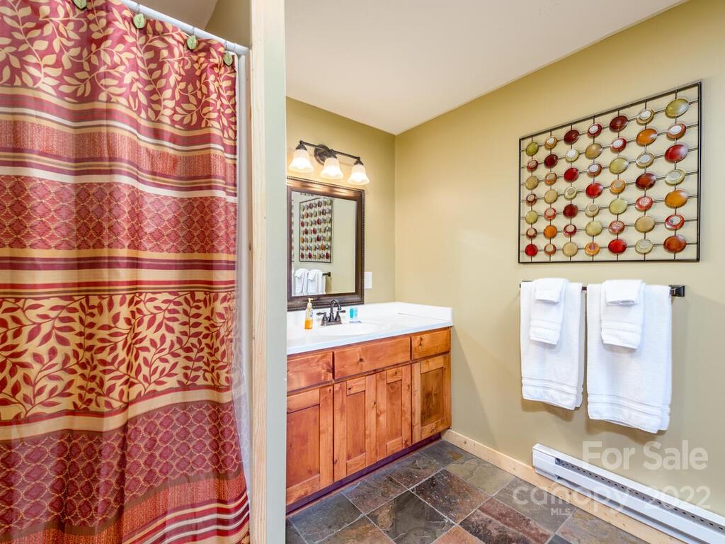 206 Legend Dr Mill Spring, Unit 8 Mill Spring, NC 28756 - Photo 43 of 47 a bathroom with a sink and a mirror