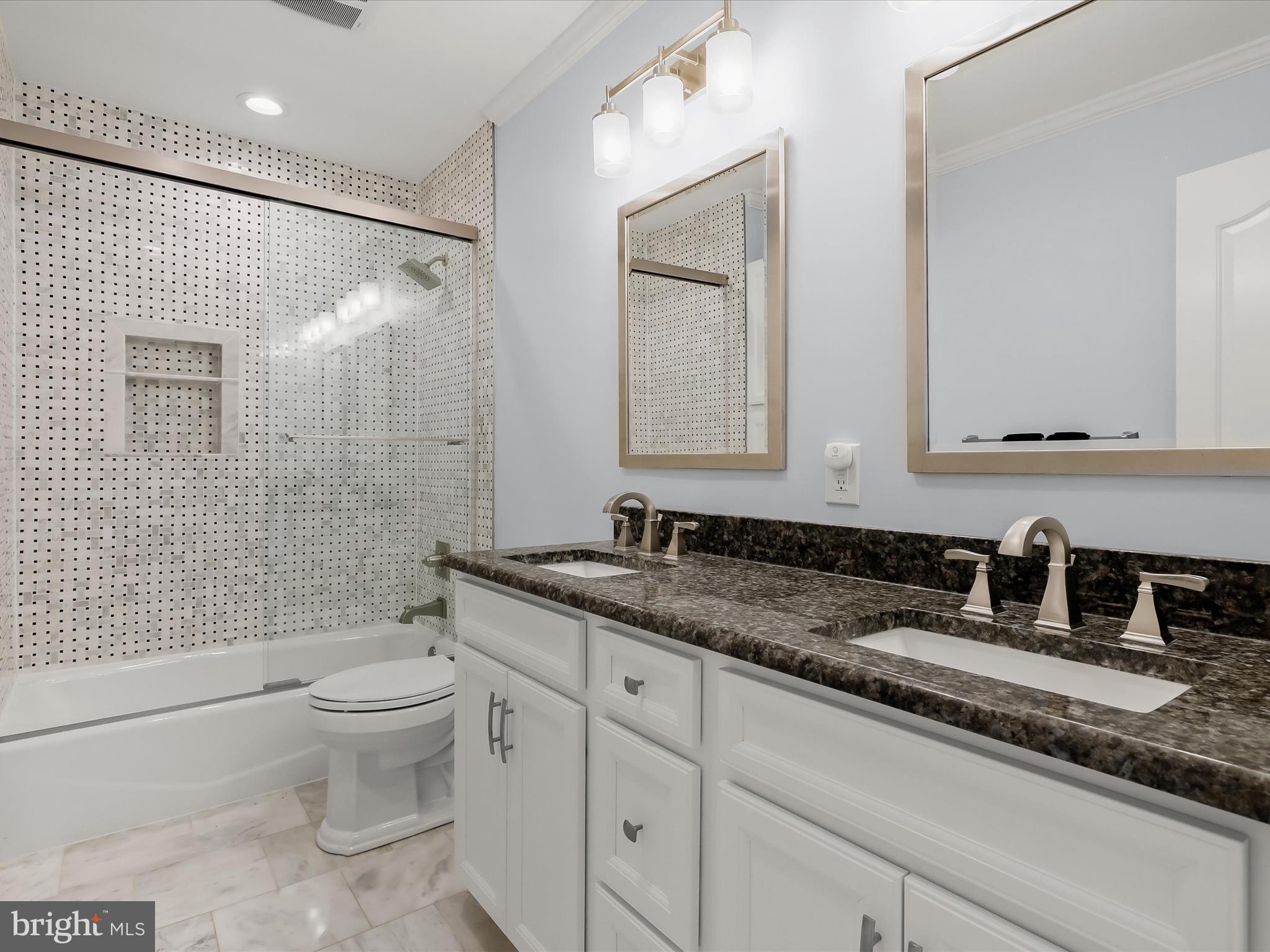 2612 Monkton Road Monkton, MD 21111 - Photo 43 of 81 a bathroom with a granite countertop sink a toilet a mirror and shower