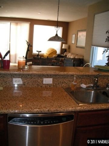13755 Seabiscuit Drive Reno, NV 89521 - Photo 2 of 12 a kitchen with granite countertop a sink and a stove