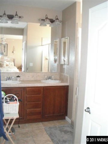 13755 Seabiscuit Drive Reno, NV 89521 - Photo 9 of 12 a bathroom with a sink and a mirror