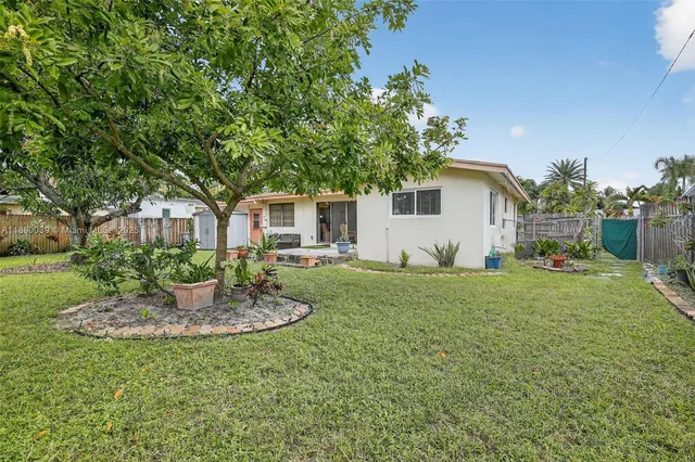 a view of a backyard with large trees