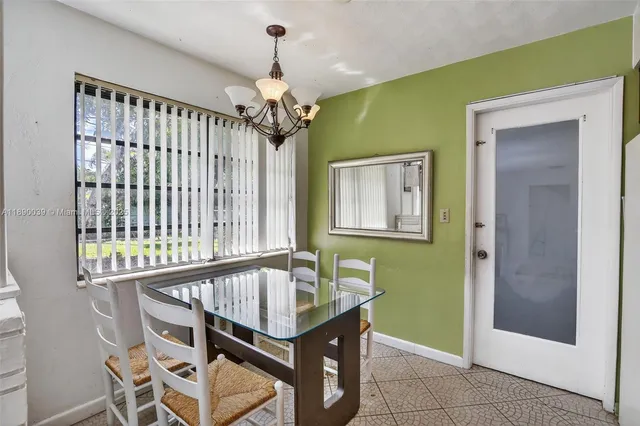 a dining room with furniture and window