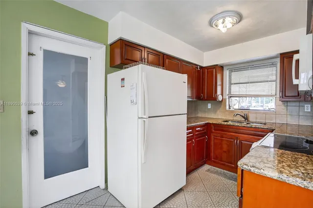 a white refrigerator freezer sitting inside of a kitchen