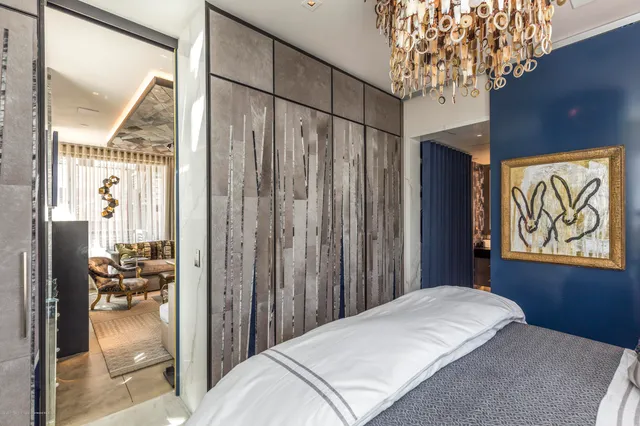 a bedroom with furniture and a large window