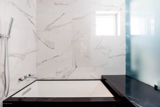 a bathroom with a bathtub and a shower