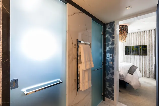 a bathroom with a granite countertop sink a toilet and a mirror