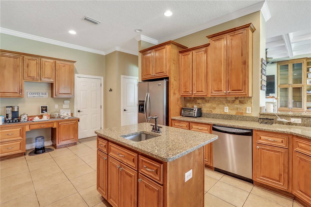203 Liberty Square Brunswick, GA 31525 - Photo 21 of 59 Kitchen with center island with vegetable sink. Double sink is on the right of the dishwasher.
