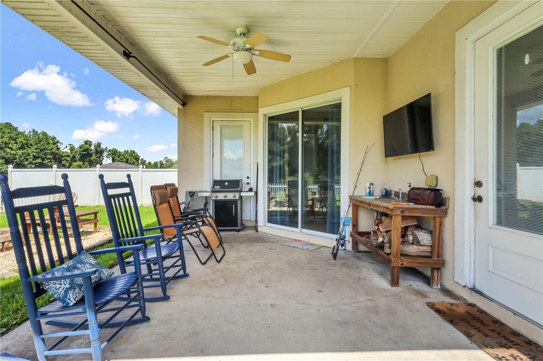 203 Liberty Square Brunswick, GA 31525 - Photo 38 of 59 Covered porch next to fire pit. The door on the right is next to the kitchen, sliding glass doors in the 2nd master bedroom and door on left with blinds in the bathroom.