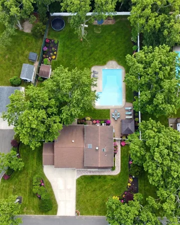 an aerial view of a house with pool outdoor seating and yard