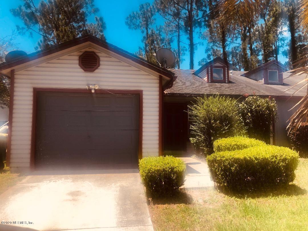 2464 Spring Vale Road Jacksonville, FL 32246 - Photo 1 of 1 a backyard of a house with yard and outdoor seating