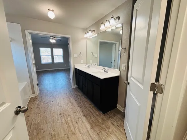 a bathroom with a sink a mirror and a shower