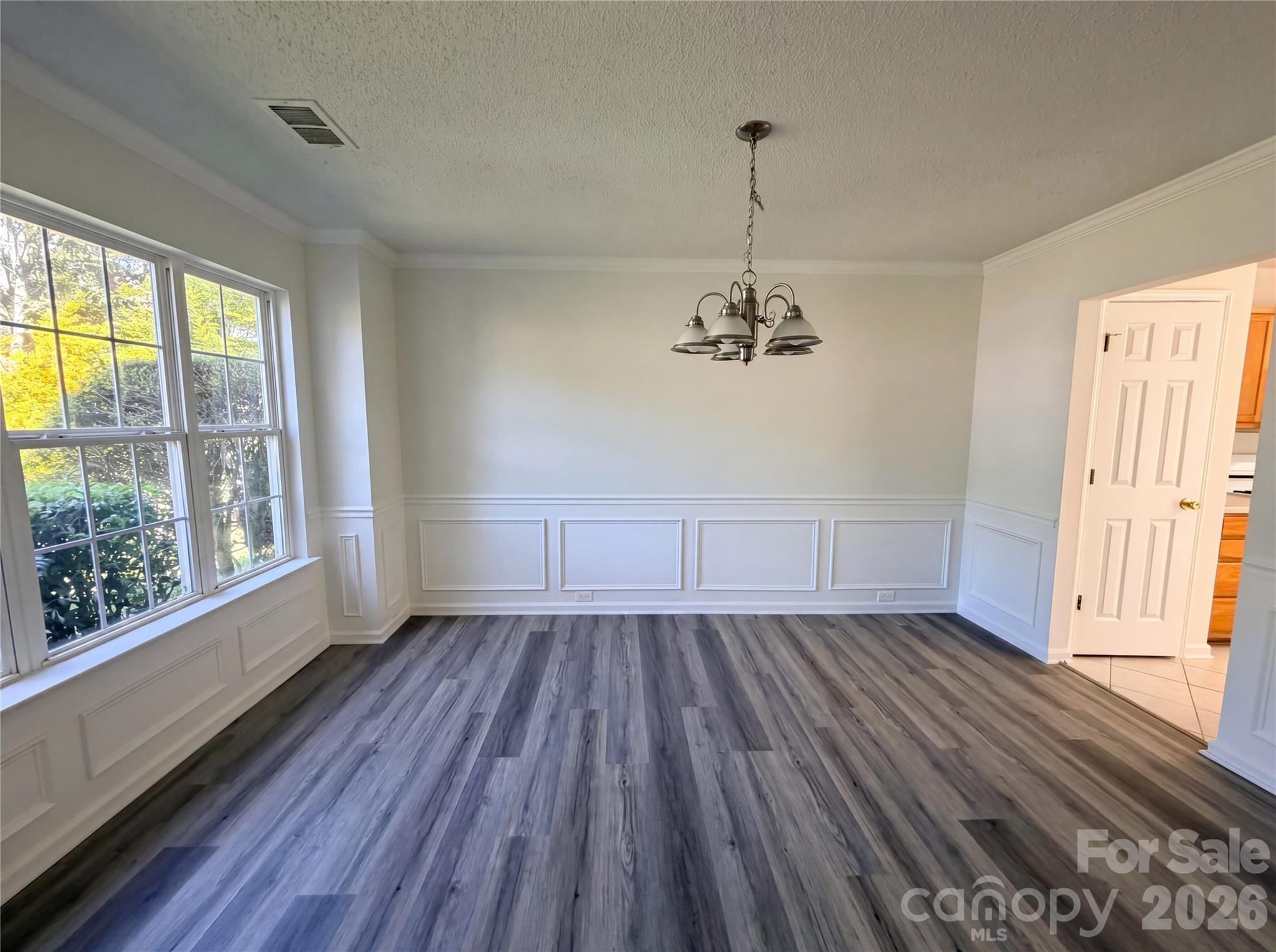 7423 Henderson Park Road Huntersville, NC 28078 - Photo 6 of 16 a view of empty room with wooden floor and fan