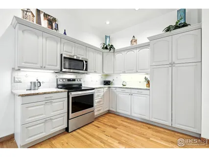 a living room with furniture a fireplace and a floor to ceiling window