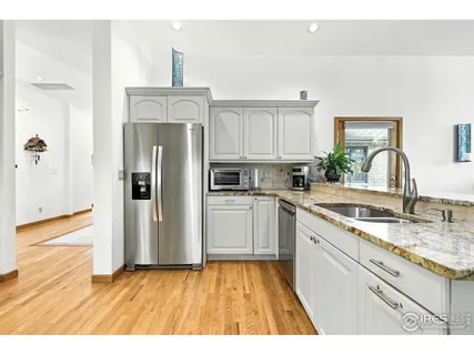 a living room with furniture fireplace and a large window
