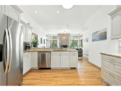 a living room with furniture and view of kitchen