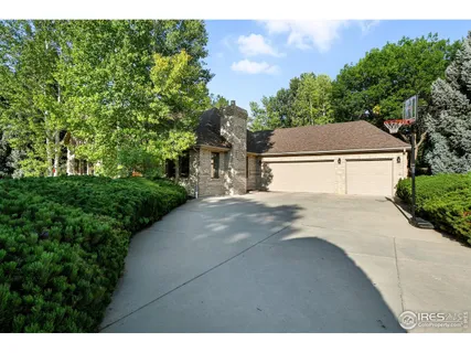 a living room with furniture a large window and a flat screen tv