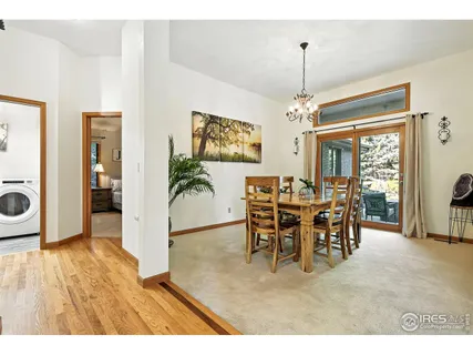 a view of a dining room with furniture and a chandelier