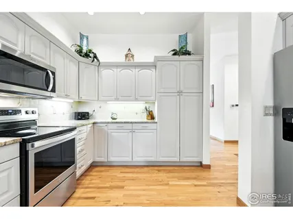 a kitchen with stainless steel appliances granite countertop a sink and a refrigerator